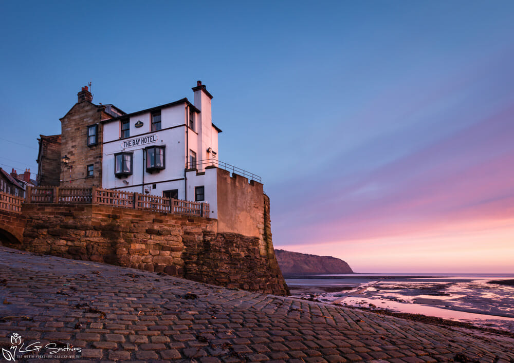 March's image for the 2027 Robin Hoods Bay Calendars is the features The Bay Hotel at sunrise
